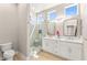 Modern bathroom featuring a glass shower, double vanity, and contemporary fixtures at 10557 Shoalhaven Dr, Las Vegas, NV 89134