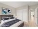Staged bedroom with calming decor, light wood floors, and closet with sliding doors at 10557 Shoalhaven Dr, Las Vegas, NV 89134