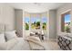 Cozy bedroom with a bay window, scenic golf course views, and stylish furnishings at 10557 Shoalhaven Dr, Las Vegas, NV 89134