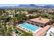 Inviting community pool surrounded by lounge chairs, lush greenery and mountain views at 10557 Shoalhaven Dr, Las Vegas, NV 89134