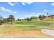 Scenic view of the manicured golf course with mature trees and well-maintained greens at 10557 Shoalhaven Dr, Las Vegas, NV 89134