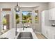Gourmet kitchen with a large island, stainless steel sink, and a view of the lush backyard at 10557 Shoalhaven Dr, Las Vegas, NV 89134