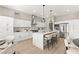 Spacious kitchen with center island, stainless steel appliances, and seamless flow to breakfast and dining areas at 10557 Shoalhaven Dr, Las Vegas, NV 89134