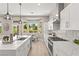 Bright, modern kitchen with island, stainless appliances and a breakfast nook overlooking beautiful landscaping at 10557 Shoalhaven Dr, Las Vegas, NV 89134