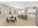 Open-concept kitchen features island, dining area, and bar seating at 10557 Shoalhaven Dr, Las Vegas, NV 89134