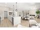 Open concept design featuring a modern kitchen with island bar and living area with fireplace at 10557 Shoalhaven Dr, Las Vegas, NV 89134