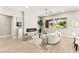 Bright living room with modern fireplace and two expansive windows with lovely green outdoor views at 10557 Shoalhaven Dr, Las Vegas, NV 89134