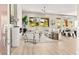 Bright, open living room featuring large windows and stylish decor, flowing into the dining area at 10557 Shoalhaven Dr, Las Vegas, NV 89134