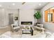 Bright open-concept living room showcases a fireplace and windows offering views of lush greenery at 10557 Shoalhaven Dr, Las Vegas, NV 89134