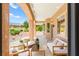 Covered outdoor patio with comfortable seating and scenic views of the lush landscaping at 10557 Shoalhaven Dr, Las Vegas, NV 89134