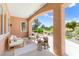 Inviting covered patio with comfortable seating and views of a lush, green landscape at 10557 Shoalhaven Dr, Las Vegas, NV 89134