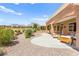 Covered patio with stylish seating area overlooks the landscaped yard and mountain views at 10557 Shoalhaven Dr, Las Vegas, NV 89134
