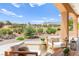 Outdoor patio with scenic view of golf course, comfortable seating, and desert landscaping at 10557 Shoalhaven Dr, Las Vegas, NV 89134