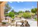 Relaxing patio space with outdoor furniture and scenic views of the surrounding greenery at 10557 Shoalhaven Dr, Las Vegas, NV 89134