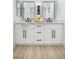 Bathroom vanity with double sinks, modern black fixtures, and ample storage space at 10709 Hunters Woods Pl, Las Vegas, NV 89134
