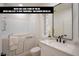 Bright bathroom features a walk-in tub, white cabinets, granite countertops, and a large mirror at 10709 Hunters Woods Pl, Las Vegas, NV 89134