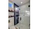 Clean bathroom features a glass shower, sleek fixtures, and neutral color scheme with floating shelves at 10709 Hunters Woods Pl, Las Vegas, NV 89134