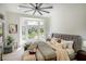 Comfortable bedroom features a large window with scenic outdoor views and a ceiling fan at 10709 Hunters Woods Pl, Las Vegas, NV 89134