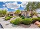 Single-story home with meticulously maintained desert landscaping and mature trees at 10709 Hunters Woods Pl, Las Vegas, NV 89134