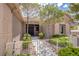 Charming single-story home featuring a gated front yard with desert landscaping and a covered entryway at 10709 Hunters Woods Pl, Las Vegas, NV 89134