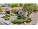 Attractive front yard with desert landscaping, gravel, and mature trees enhance the curb appeal of this residence at 10709 Hunters Woods Pl, Las Vegas, NV 89134