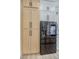 Modern stainless steel refrigerator with digital display next to light wood cabinets at 10709 Hunters Woods Pl, Las Vegas, NV 89134