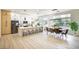 Modern kitchen with a large island, stainless steel appliances, and an adjacent dining area at 10709 Hunters Woods Pl, Las Vegas, NV 89134