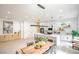 Contemporary kitchen featuring a large island with bar seating, stainless appliances, and an open dining area at 10709 Hunters Woods Pl, Las Vegas, NV 89134