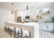 Contemporary kitchen with white cabinets, a large island with seating, and modern pendant lighting at 10709 Hunters Woods Pl, Las Vegas, NV 89134