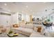 Bright and airy living room with an open floor plan, modern decor, and ample seating at 10709 Hunters Woods Pl, Las Vegas, NV 89134