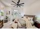 Bright main bedroom with a cozy bay window and a stylish ceiling fan for added comfort at 10709 Hunters Woods Pl, Las Vegas, NV 89134