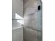 Modern shower showcasing unique tile work and sleek glass doors for a spa-like retreat at 10709 Hunters Woods Pl, Las Vegas, NV 89134
