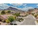 A lovely street view showcases mountain views beyond well-kept homes and landscaped yards at 10709 Hunters Woods Pl, Las Vegas, NV 89134