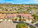 Sweeping aerial view of a meticulously planned community featuring lush landscaping, common green spaces, and manicured streetscapes at 10809 Garden Mist Dr # 1004, Las Vegas, NV 89135