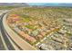 Sprawling neighborhood aerial view with community pool and highway access, displaying community layout and convenient location at 10809 Garden Mist Dr # 1004, Las Vegas, NV 89135
