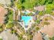 Overhead aerial view of a community pool surrounded by trees, landscaping, and homes at 10809 Garden Mist Dr # 1004, Las Vegas, NV 89135
