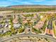 Stunning aerial view showcases the community's layout, highlighting the meticulously planned neighborhood, lush landscaping, and mountain backdrop at 10809 Garden Mist Dr # 1004, Las Vegas, NV 89135