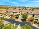 Elevated view captures meticulously landscaped townhomes with garages, complemented by mountain views, and well-maintained surroundings at 10809 Garden Mist Dr # 1004, Las Vegas, NV 89135
