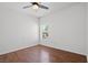 Bright bedroom featuring a ceiling fan, wood laminate flooring, and a window with blinds at 10809 Garden Mist Dr # 1004, Las Vegas, NV 89135