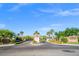 Elegant gated community entrance featuring meticulously manicured landscaping, serene palm trees, and a welcoming atmosphere at 10809 Garden Mist Dr # 1004, Las Vegas, NV 89135