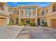 Townhouse complex courtyard featuring manicured landscaping and covered walkways at 10809 Garden Mist Dr # 1004, Las Vegas, NV 89135