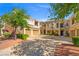 Inviting townhome complex featuring multiple units, garages, and professionally landscaped surroundings, creating a welcoming community atmosphere at 10809 Garden Mist Dr # 1004, Las Vegas, NV 89135