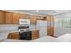 Functional kitchen with ample wood cabinets, white appliances at 10809 Garden Mist Dr # 1004, Las Vegas, NV 89135