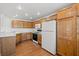 Efficient kitchen layout with wooden cabinets and neutral countertops at 10809 Garden Mist Dr # 1004, Las Vegas, NV 89135