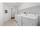 Functional laundry room with a washer and dryer, shelving, and a utility sink at 10809 Garden Mist Dr # 1004, Las Vegas, NV 89135