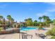 A luxurious pool area with palm trees, water fountain, covered seating offering a resort-style oasis perfect for relaxation at 10809 Garden Mist Dr # 1004, Las Vegas, NV 89135