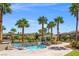 Inviting pool and spa area surrounded by mature palm trees providing a private oasis with an adjacent shaded seating area at 10809 Garden Mist Dr # 1004, Las Vegas, NV 89135