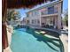Spacious backyard pool with a tiki hut, complemented by a two-story home with a balcony at 1105 Enderly Ln, Las Vegas, NV 89144