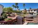 Expansive backyard featuring palm trees, a tiki hut, and lush landscaping at 1105 Enderly Ln, Las Vegas, NV 89144
