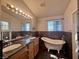 Bathroom featuring double sinks and clawfoot tub, creating a luxurious and stylish space at 1105 Enderly Ln, Las Vegas, NV 89144